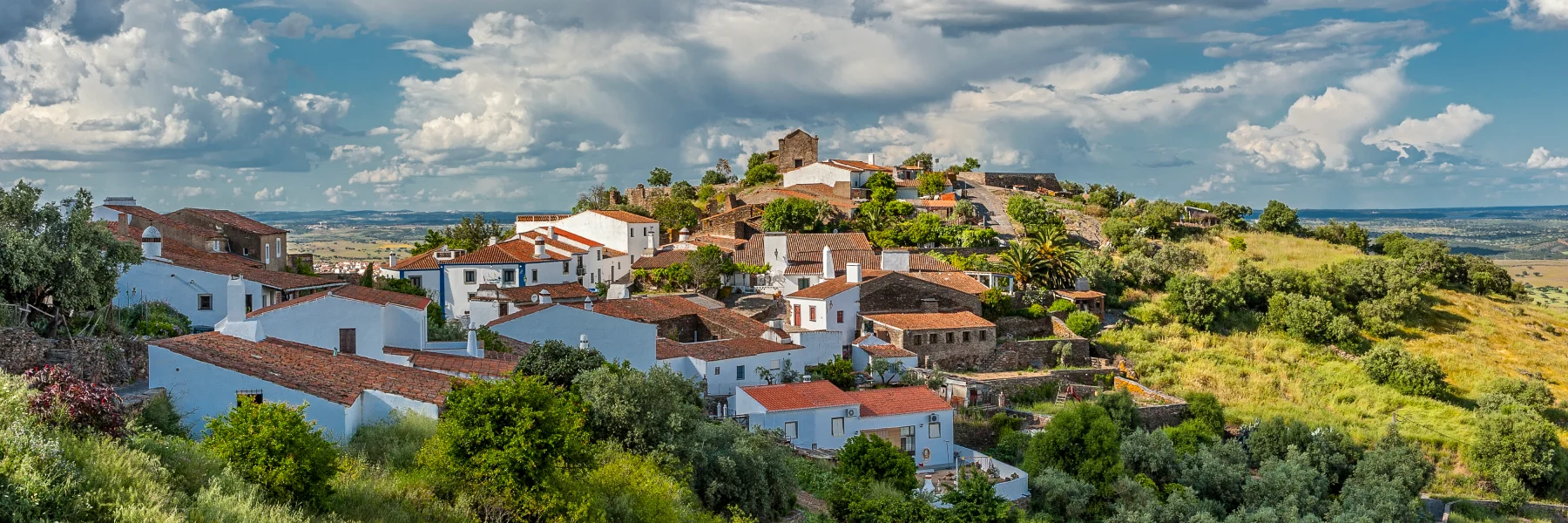 Discover Monsaraz, Portugal, a hilltop medieval village with cobbled streets and sweeping Alentejo views